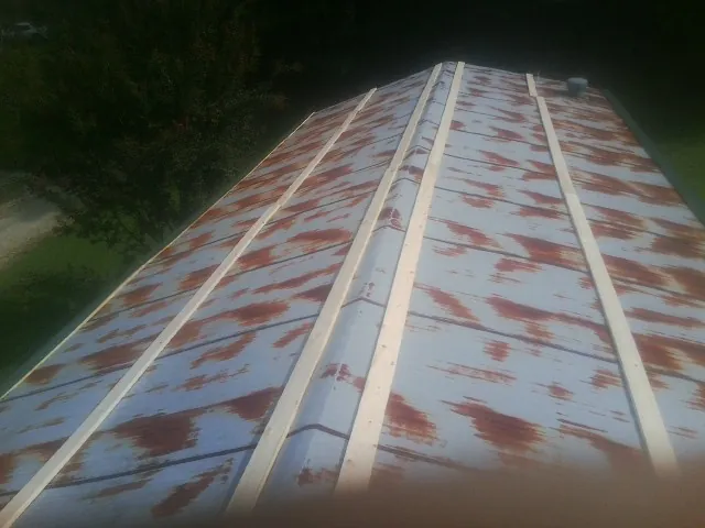 Rusted metal roof panels with new wood purlins before replacement — Storm Damage Roof Repair in Dania by Roofing Brothers